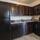 Dark cabinetry of kitchen in Orangewood Park apartment for rent