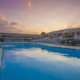Swimming pool outside of Orangewood Park townhomes with beautiful Levittown sunset